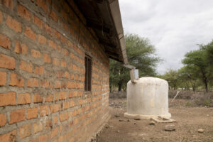 Rainwater Tank at a home in East Africa. Constructed of concrete and attached by gutters to brick building